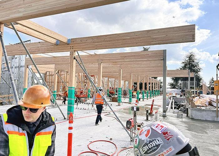 a building is under construction with large cross-laminated timber beams and tibler posts